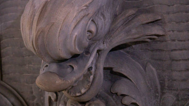 istock Snake head carved in ancient stone fountain 1437017831