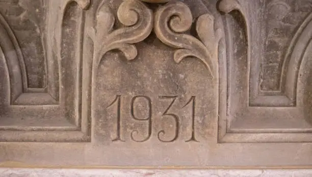 Photo of Old fountain year engraving made of stone