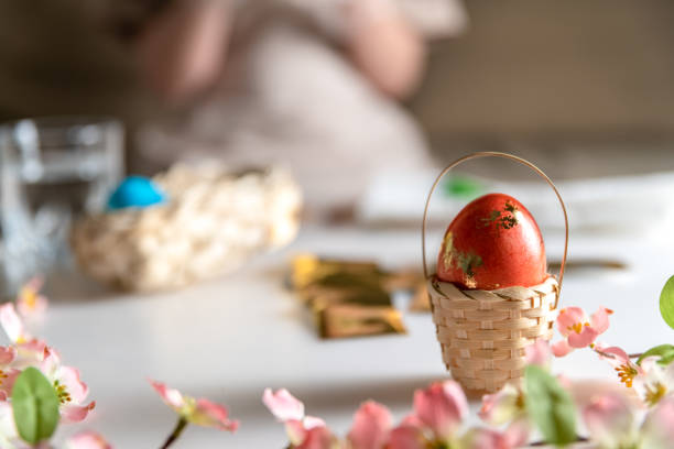 istock girl at home in the kitchen dyes eggs for Easter 1437018118