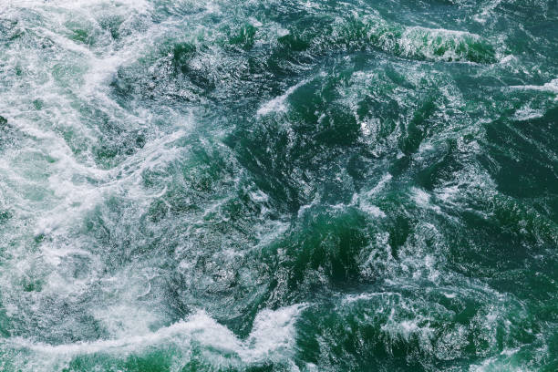 istock Stormy ocean water with waves and foam, top view, texture 1437025747