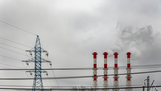 Overcast, winter sky with power lines and smokestacks in Moscow.