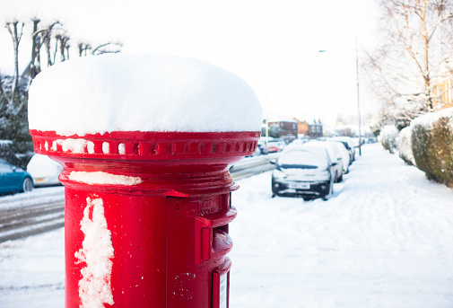 Deep snow on top of a British postbox the morning after heavy snowfall.
