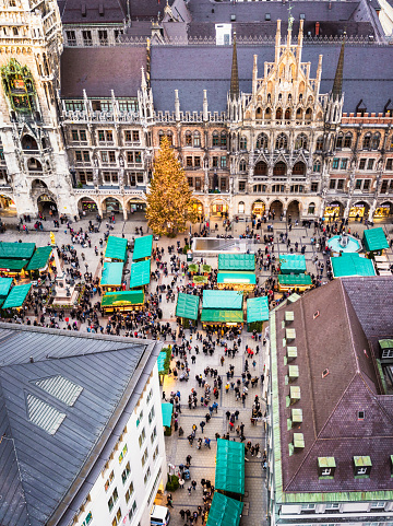 A high angle view over Marienplatz in December, with people visiting the city's annual Christmas Markets.