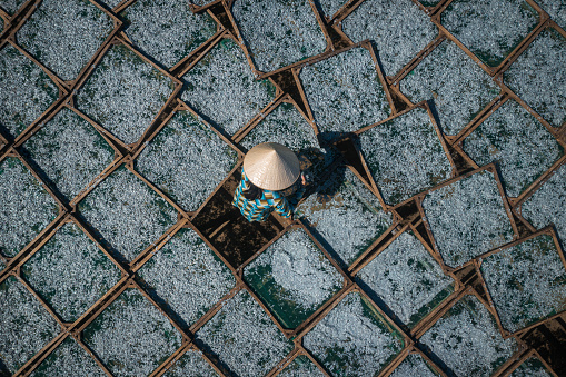 Drone view of a woman is drying steaming anchovies in Nha Trang city, Khanh Hoa province, central Vietnam