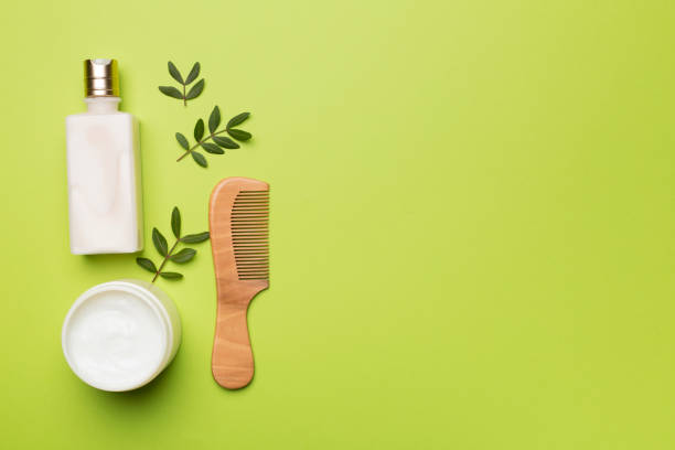 istock Shampoo and mask with herbal extract and comb on color background, top view 1437031390