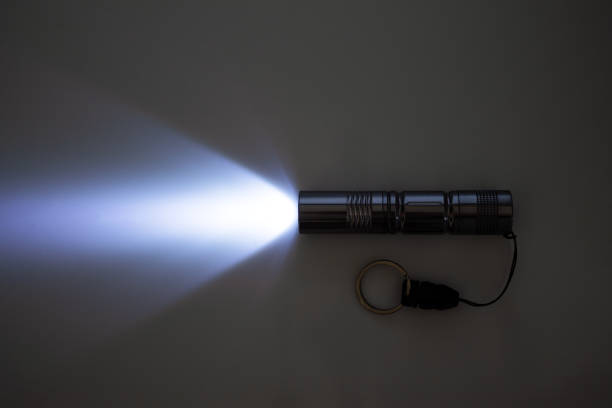 luminous flux from a small pocket flashlight, on a gray background