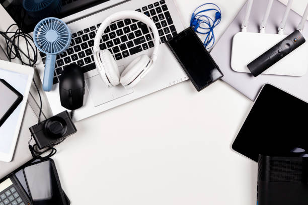 istock Old laptop computers, digital tablets, mobile phones, many used electronic gadgets devices on white table. Top view. Planned obsolescence, e-waste, electronic waste for recycling concept 1437032902