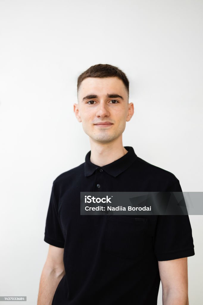 Young Man In A Black Polo Shirt On White Background Stock Photo ...