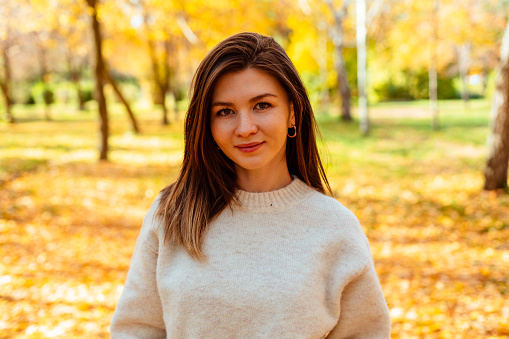 Portrait of beautiful woman in autumn park