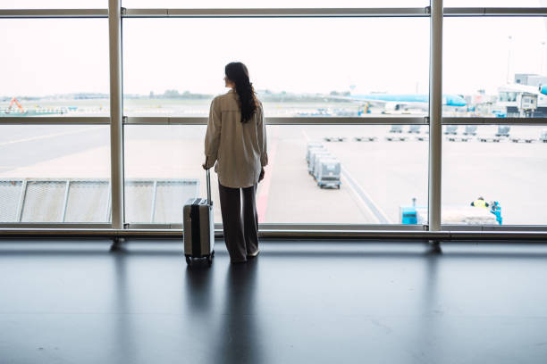 istock Woman with suitcase is going waiting for the next flight 1437035953