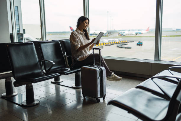 istock Young female passenger waiting for flight at airport lounge 1437036621