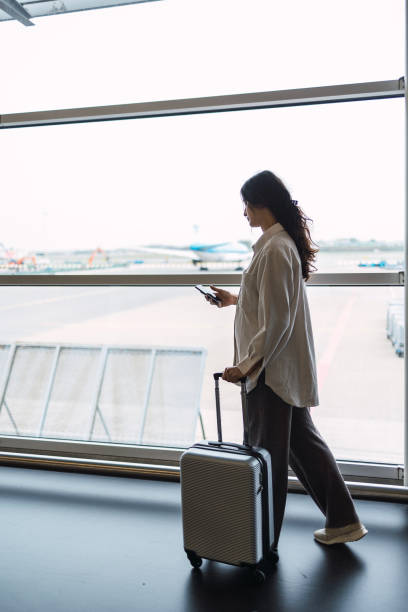 istock Latin woman with suitcase is going to board on the next flight 1437036702