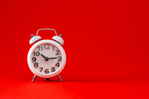 Alarm clock on red background