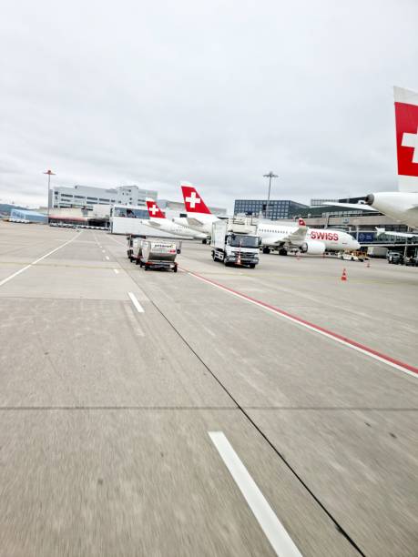 Airfield of the Zurich Airport ZRH with several parked aircrafts. The image was captured suring autumn season.