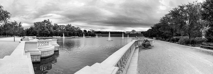 Wide angle panorama of Forest Park, which opened in 1876, is a public park in western St. Louis, Missouri.  The park covers 1,324 acres making it the largest city park in the United States. For comparison, New York City's Central park is 843 acres. Forest Park includes walking trails, fishing lakes, an art museum, zoo and a public golf course. This view of the Grand Basin was designed for The World's Fair in 1904 and was restored in 2003.