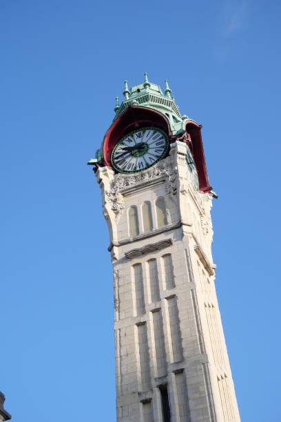 istock Low angle shot of a tower clock with blue sky background 1437041822