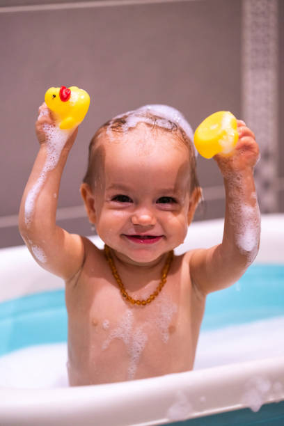 istock Happy baby girl is having a bath 1437041823