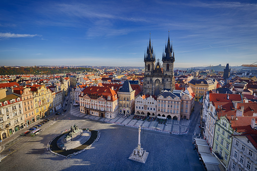 Panoramic highly detailed view from distance towards Vltava river and the famous Charles bridge in beautiful City of Prague, the capital of the Czech republic. The image is a long exposure with blurred passing boat and constant tourist crowds passing the iconic bridge sunlit by the setting Sun during afternoon on a clear day. Shot on Canon EOS R system with premium lens for highest quality.