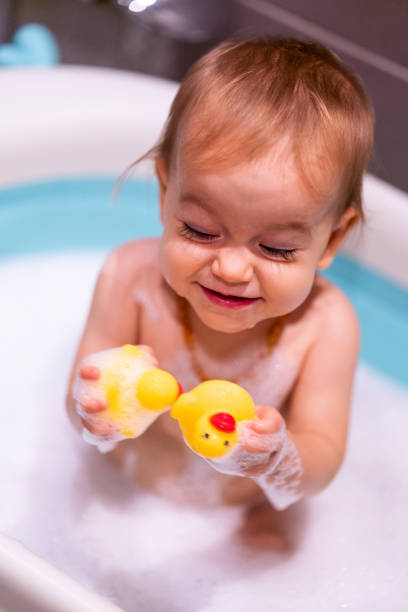 istock Happy baby girl is having a bath 1437041892