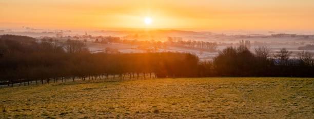 istock Panoramic view of a dramatic sunset over the field 1437043754