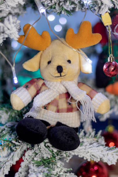 istock Christmas moose doll on a snowy christmas tree 1437045837