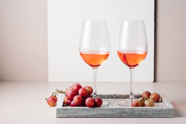 istock Two glasses of rose wine and red grapes. 1437050312