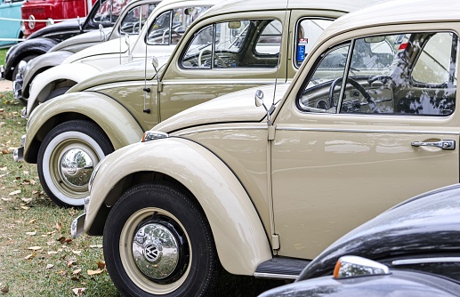 Leiria, Portugal – October 16, 2022: A row of various VW model Beetle (Kafer) cars during an exhibition in a park