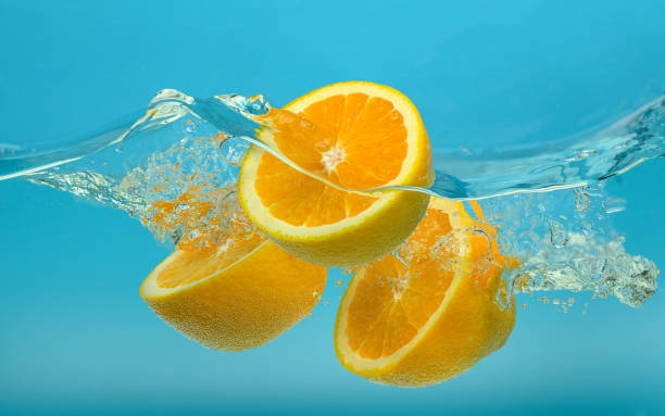 istock Oranges falling in water with splash on turquoise blue background 1437052085