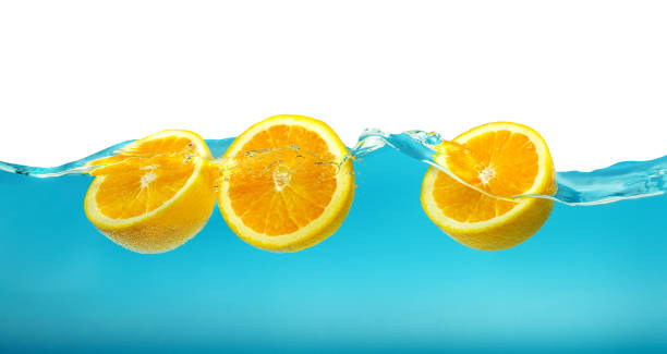 istock Oranges in turquoise water with splash isolated on white 1437052103