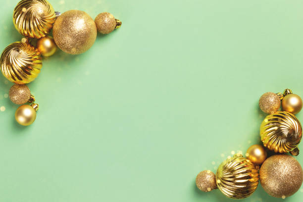istock Christmas card with golden decorations on green background 1437052165