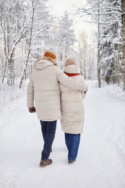 istock Couple Walking in Winter Forest 1437052330