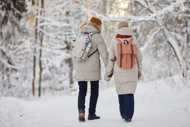 istock Couple With Backpacks Hiking in Winter Forest 1437052335