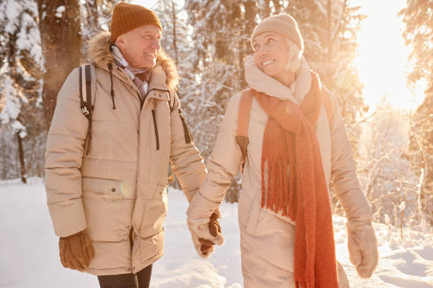 istock Senior Couple Holding Hands in Winter 1437052346