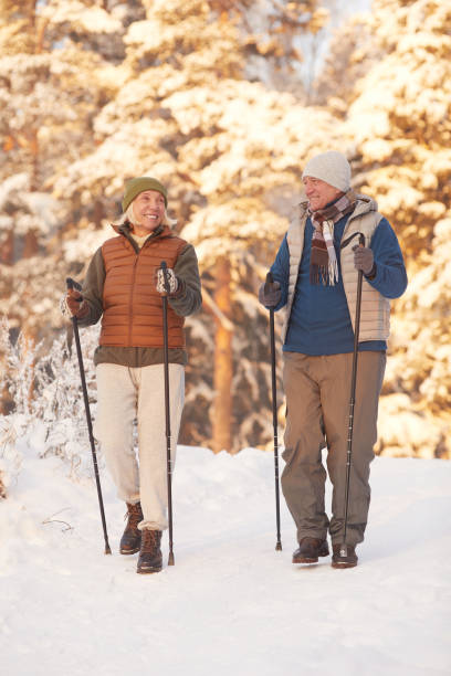 istock Senior Couple Enjoying Nordic Walk 1437052367