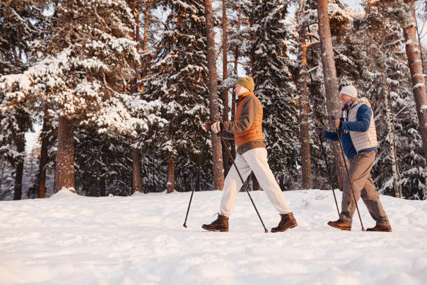 istock Active Senior Couple Walking in Winter Forest 1437052385