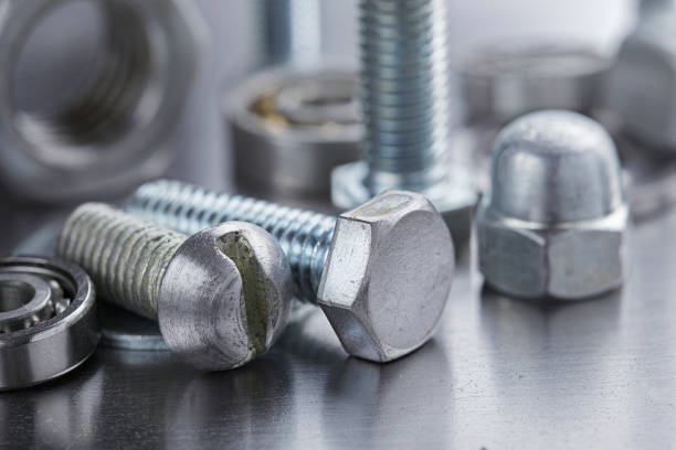 istock set of different nuts, bolts, screws, washers and drill bits,thread tap and mill cutters on steel plate background. Locksmithing deal. 1437053528