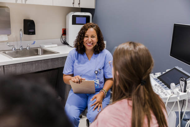 istock Female ultrasound tech smiles at unrecognizable couple 1437053899