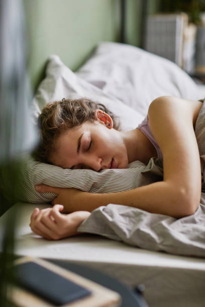 istock Tired woman sleeping in her bed 1437056174