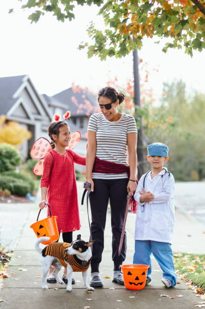 istock Young Family Trick Or Treating Together And Posing For Camera 1437056708