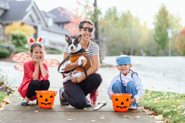 istock Young Family Trick Or Treating Together And Posing For Camera 1437056709