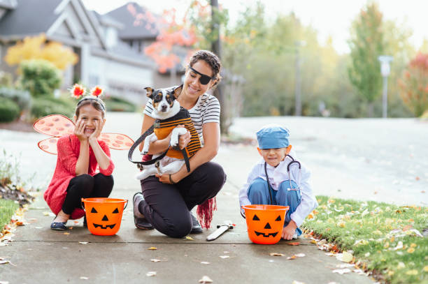 istock Young Family Trick Or Treating Together And Posing For Camera 1437056714