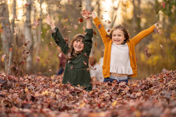 istock Children Playing in the Leaves 1437057682