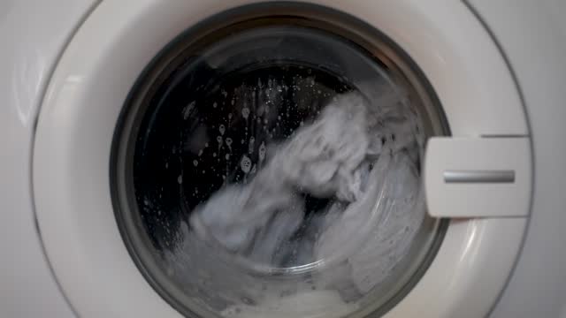 close up of working washing machine in the bath