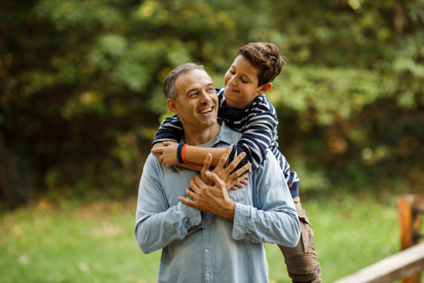 istock Happy single father and son having fun while talking in nature. 1437063261