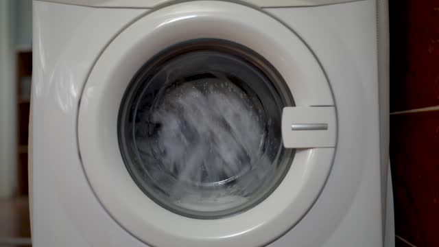 close up of working washing machine in the bath