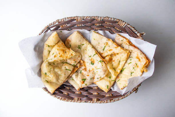 Masala Kulcha Naan served in a basket isolated on grey background top view of bangladesh food Masala Kulcha Naan served in a basket isolated on grey background top view of bangladesh food roti canai stock pictures, royalty-free photos & images