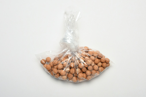Roasted crispy chickpeas in a plastic bag on the white background