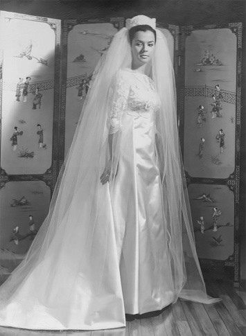 Black and white portrait: young bride posing wearing a wedding dress
