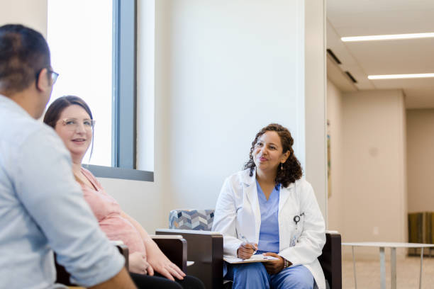 istock Female doctor sits with family 1437068084