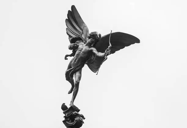 A black and white image of the Statue of Eros at Piccadilly circus, London